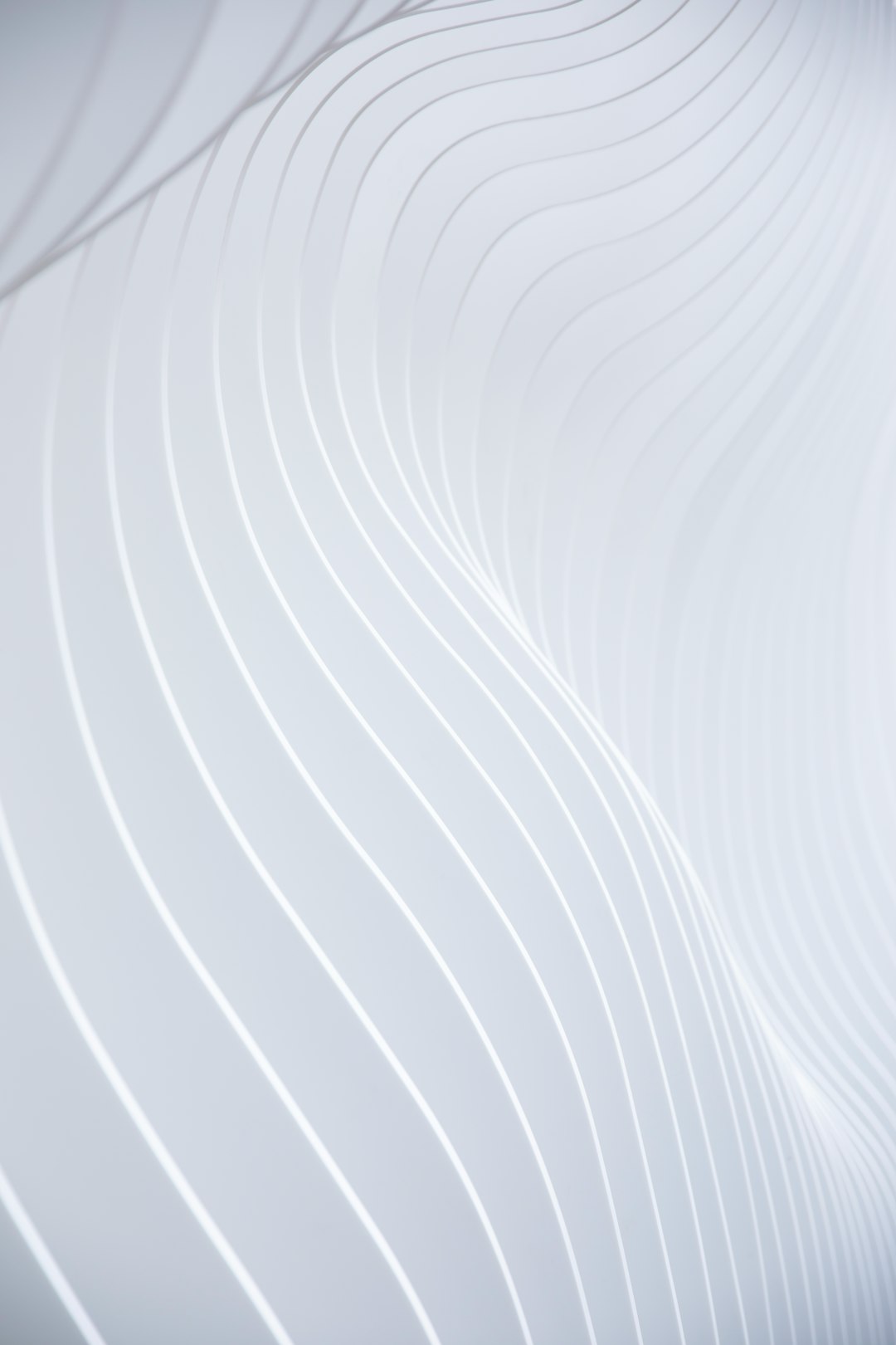a-close-up-of-a-white-wall-with-wavy-lines-75xpheqbmva