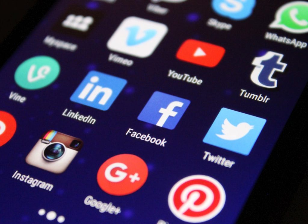 close-up-photography-of-smartphone-icons-267350 Close-up of a smartphone screen showing various social media app icons such as Facebook and Twitter.